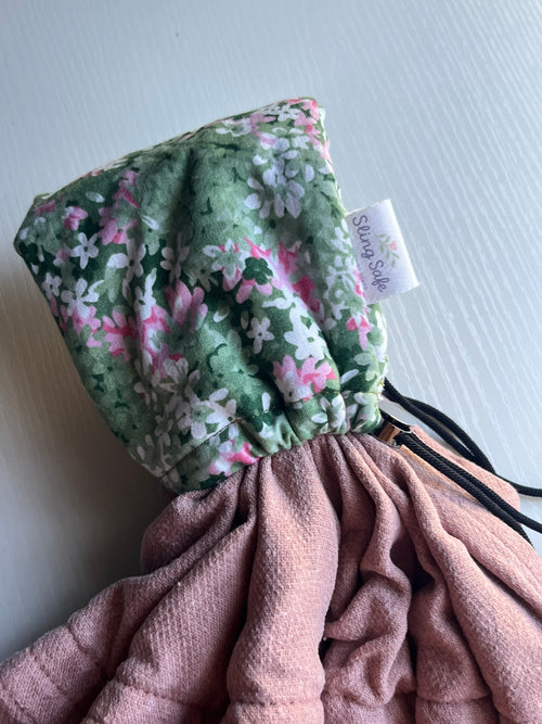 Floral drawstring bag with a visible brand tag on a light background