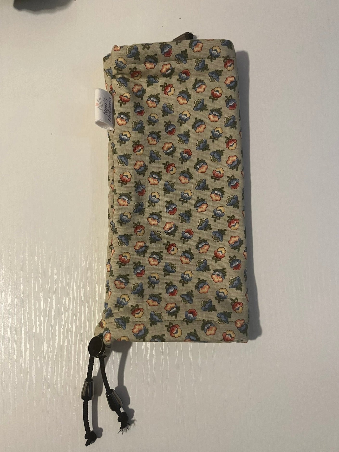 Green Floral patterned drawstring pouch on a white background