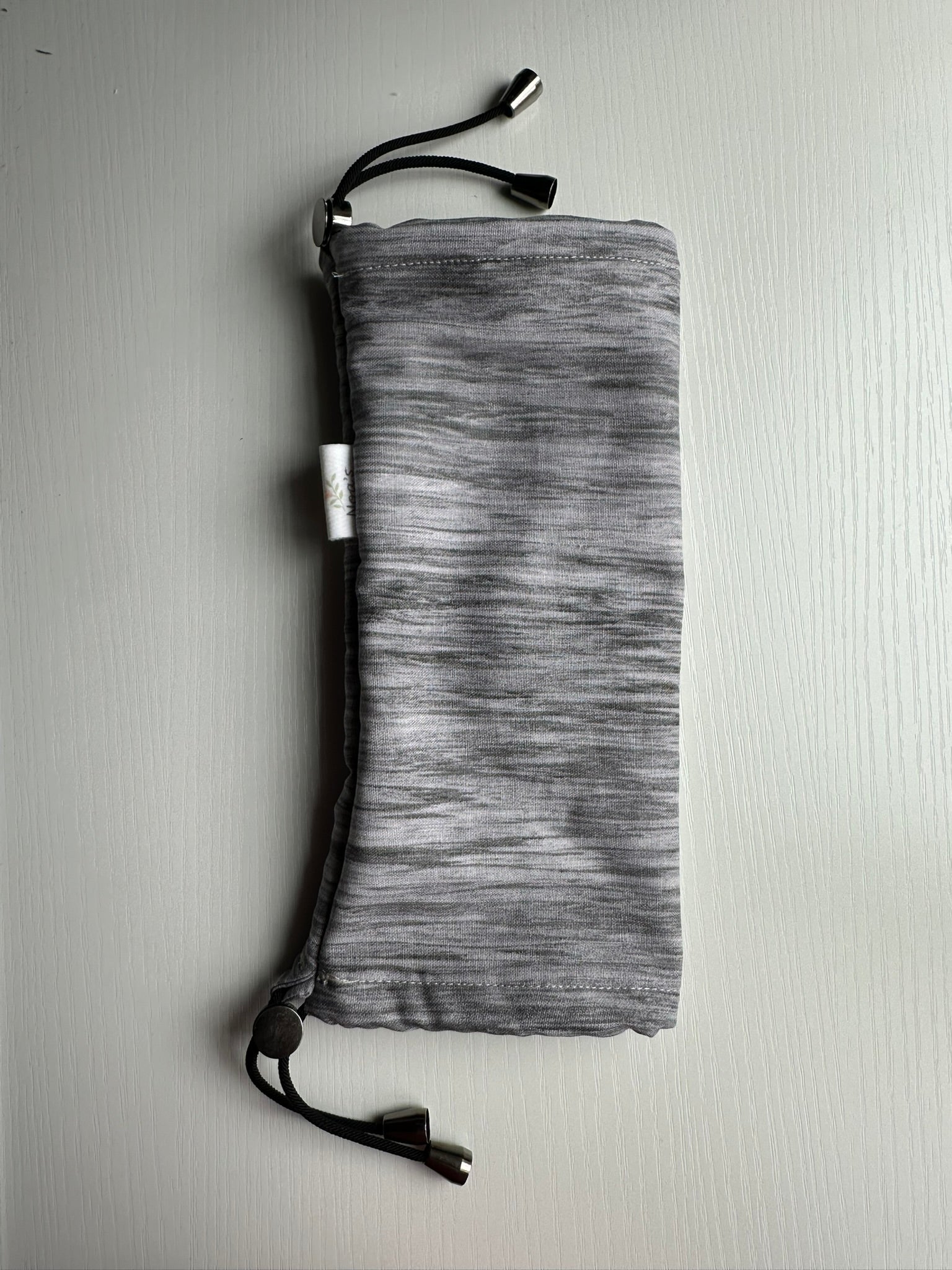 Sling Safe drawstring washing cover for ring slings, shown in the pattern Slate. Slate is a grey heather pattern. 
