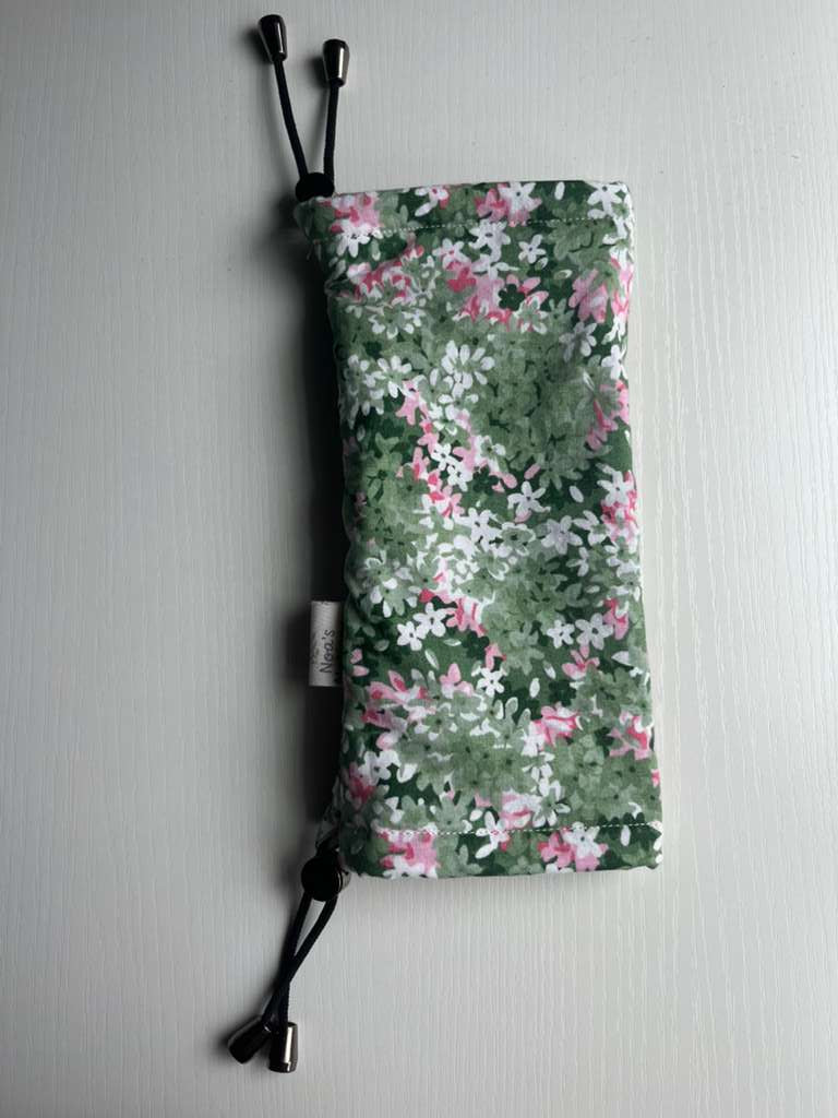 Sling Safe drawstring washing cover for ring slings, shown in the pattern Spring Garden. Spring Garden is a green, pink and white floral. 